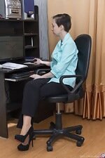 Trixie has fun getting naked in her office